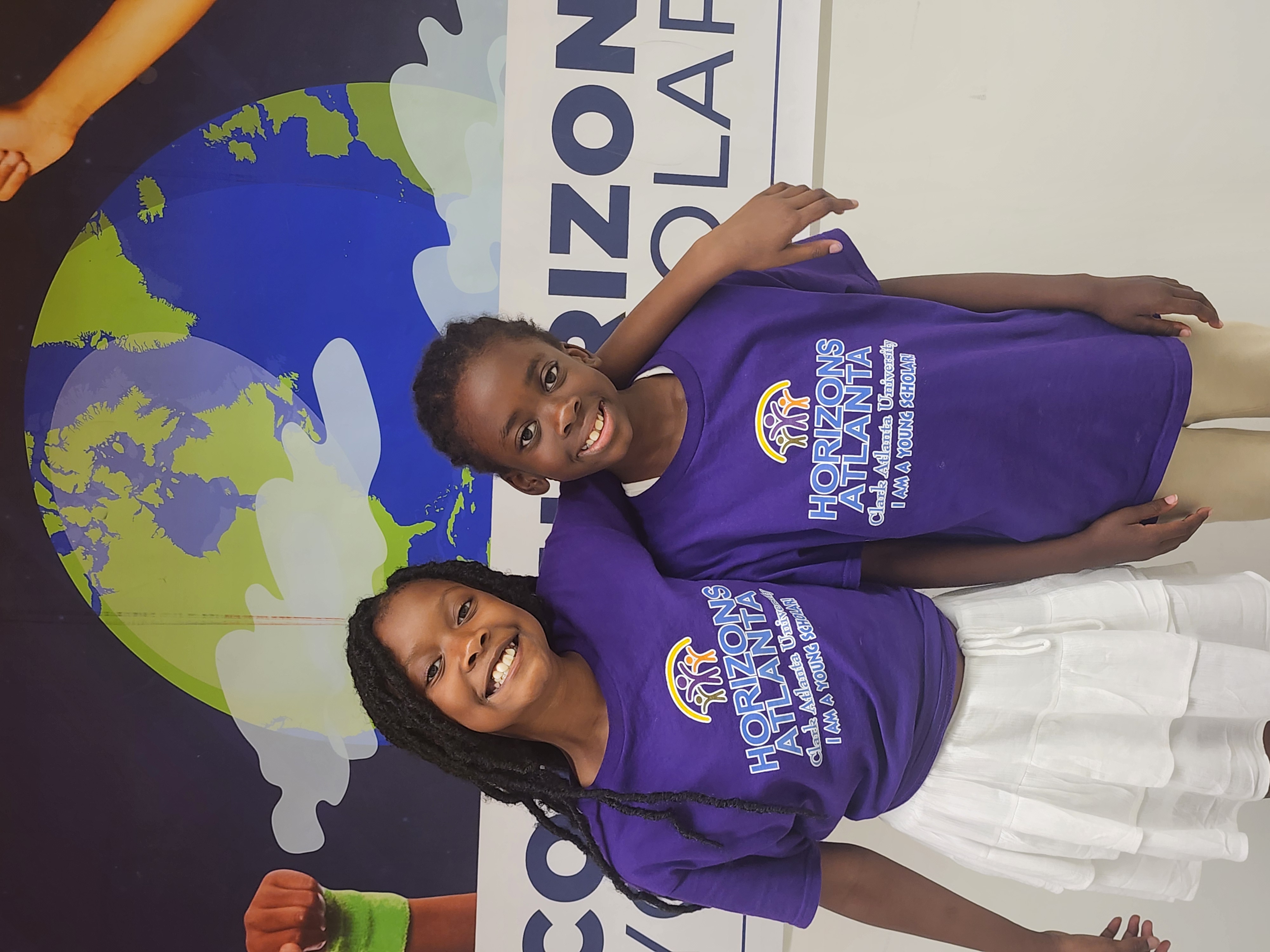 Photo of two girls from the Horizons Atlanta summer learning program at Clark Atlanta hugging for a photo